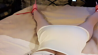 Laura, Adorned In A Seductive White Gown, Rosy Nylons, And Elevated Footwear, Bound And Silenced On A Bed